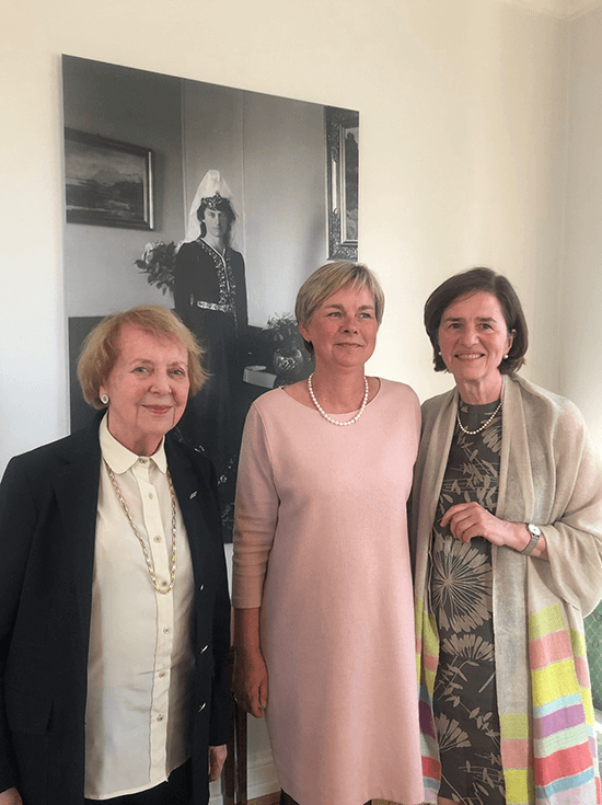 Former President Vigdís Finnbogadóttir, Madam Ambassador Eva Egesborg Hansen, and Professor Katherine Richardson, head of ROCS and cruise leader, at the Danish embassy in Reykjavík. Behind them is an enlarged photograph of Alexandrine, Queen of Denmark (and Iceland from 1918-1944) in an Icelandic national dress made and gifted to her by Icelandic women.