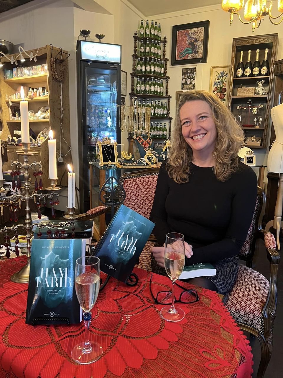 Audur at a table with copies of her new book.